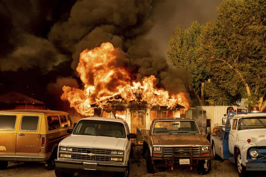 Flames consume a home as the Sugar fire, part of the Beckwourth Complex fire, moves through Doyle, California, on Saturday.