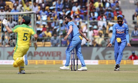 Virat Kohli (right) shows his delight after the comical mix-up cost Aaron Finch his wicket