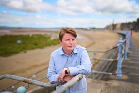 Tarnia Elsworth leans against a railing on the seafront