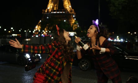 Lily Collins as Emily and Ashley Park as Mindy in Emily in Paris.