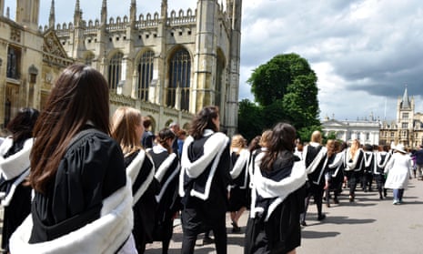 Cambridge students pass by King’s College on their way to graduation. 
