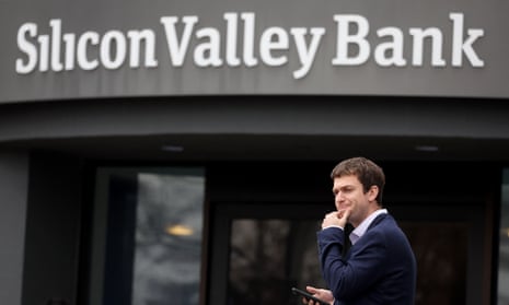 A customer stands outside of a shuttered Silicon Valley Bank (SVB) headquarters