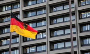 A German flag flies in front of the Bundesbank headquarters in Frankfurt, Germany.