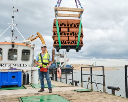 Clay bricks being winched into the North Sea.