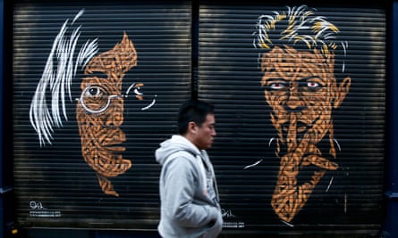 A painting of David Bowie and John Lennon on shop shutters in Brixton market