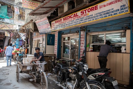 A man buys medicine from a shop at Bhagirath Palace’s pharmaceuticals market in Old Delhi.
