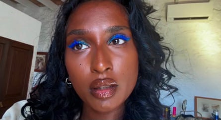A woman of colour wearing metallic-blue eye makeup