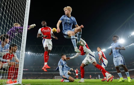Spurs keeper Antonin Kinsky (left) punches clear at an Arsenal corner as Thomas Partey and Lucas Bergvall (centre) jump in front of him.