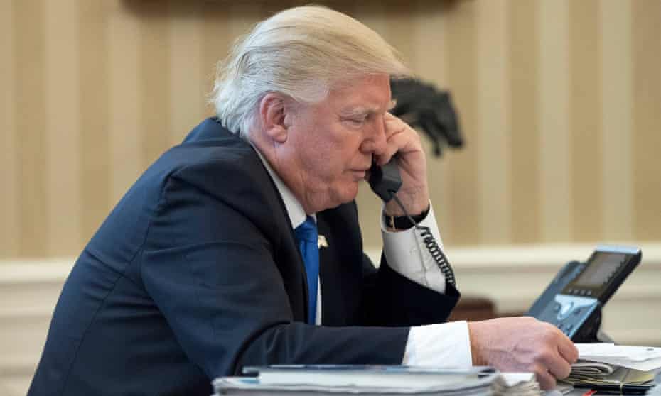 Donald Trump speaks to Angela Merkel on the phone in the Oval Office on Saturday.