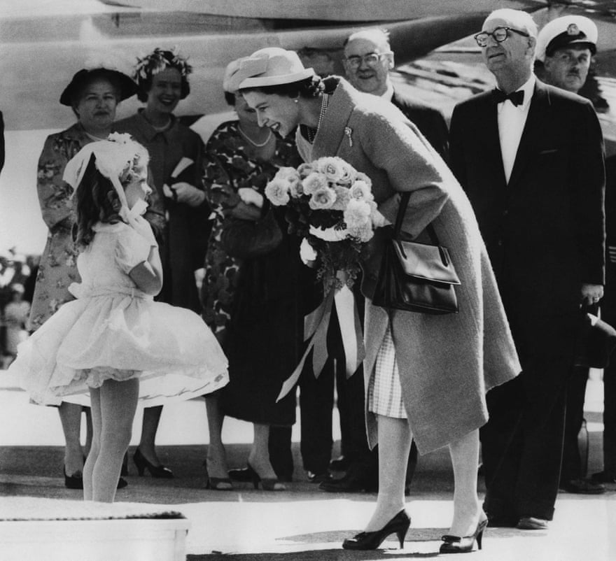 The Queen is welcomed by a little girl at her arrival at the Torbay air force base, near St John's, Newfoundland and Labrador, on 21 June 1959, during her visit to Canada.