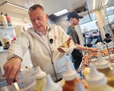 A man serving hotdogs