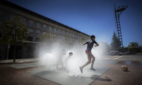 Children play in a jet stream fountain in Pamplona, Spain.