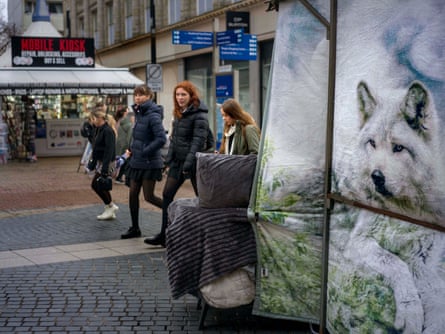 Four young people walk down a high street
