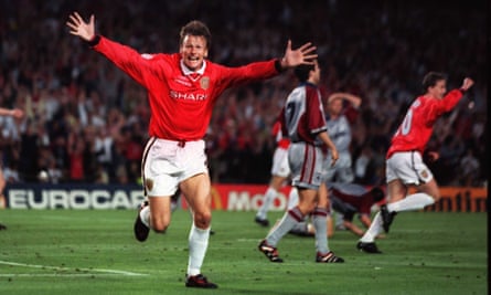 Teddy Sheringham celebrates with his arms outstretched running towards the camera after scoring the equalising goal for Manchester United against Bayern Munich in the 1999 Champions League final.