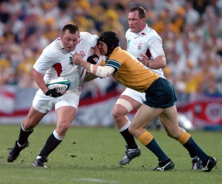 Steve Thompson (left) is tackled by Australia’s Stephen Larkham during the 2003 Rugby World Cup final.