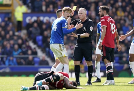 Everton’s Anthony Gordon (centre left) reacts while receiving a yellow card from referee Jonathan Moss for a foul on Manchester United’s Jadon Sancho.