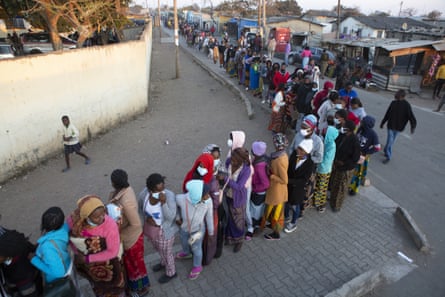 People wait in a queue at a polling station in Lusaka, Zambia on 12 August.