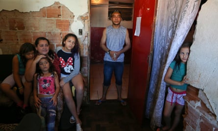 Residents Juliana Antonachi, husband Diego Paula Silva and their four daughters, stand in their apartment at the Mauá building