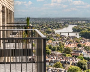 Metal-railing balconies overlooking early housing stock with the River Thames in the distance