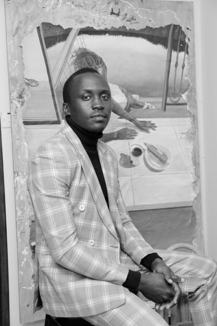A black and white image of a young man wearing a checked suit and black turtleneck in front of a painting.