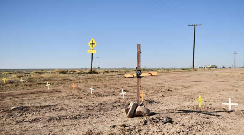 Crosses are seen near the scene of a crash between an SUV and a tractor-trailer.