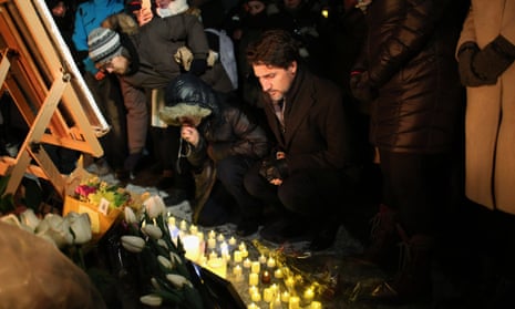 The prime minister, Justin Trudeau, places a candle on Parliament Hill during vigil for the victims who were killed in a plane crash in Iran in Ottawa, Canada. 
