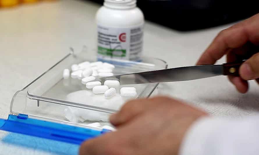 A pharmacist counts pain medication at a South Portland Pharmacy on 19 February 2014.
