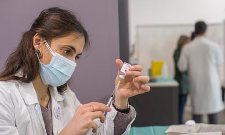 A doctor prepares the dose of the Oxford/AstraZeneca vaccine in Bologna, Italy