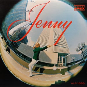 The sleeve of Rendez-Vous Avec Toi by Jenny Rock (Apex, Canada 1966), showing Jenny, shot with a fish-eye lens, standing on a  square amid tall buildings