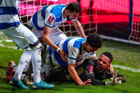 QPR keeper Jordan Archer is congratulated by his teammates after making a winning save in the penalty shootout.