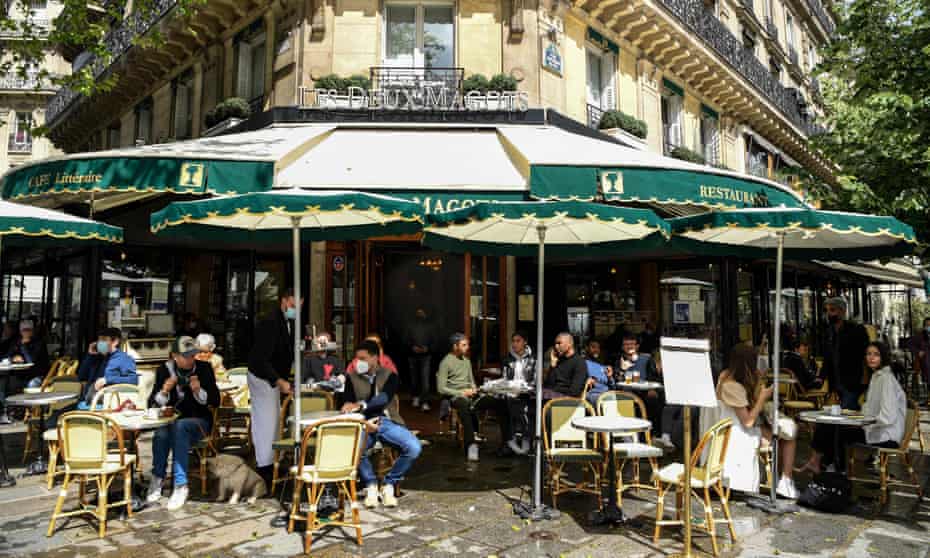 People eat out in Paris as outdoor dining reopens. Fully vaccinated people from the UK will be able to visit the EU this summer.