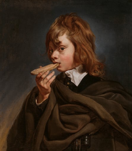 A boy looks at the painter as he bites a piece of bread