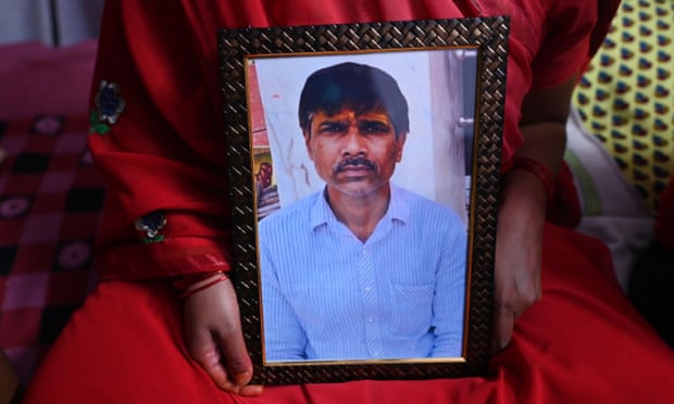 Jashoda Sahu Teli holds a picture of her slain husband, Hindu tailor Kanhaiya Lal