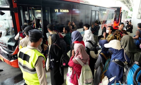 Indonesian citizens walk to a bus upon arrival at Soekarno-Hatta international airport in Tangerang, Indonesia.