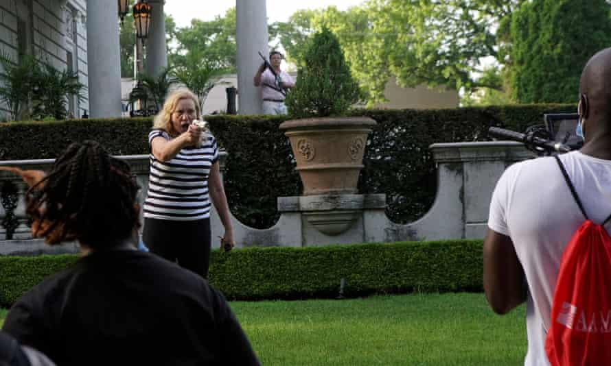 Patricia McCloskey and her husband, Mark, draw their firearms on protestors passing their home in St Louis on 28 June.