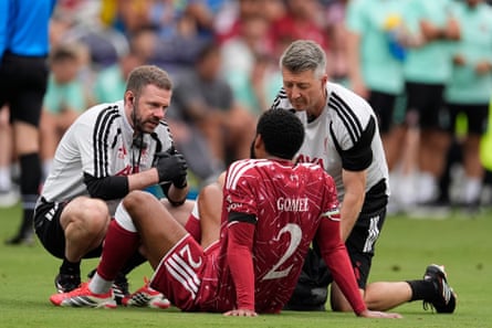 Joe Gomez is helped by trainers aft going down early pinch an injury