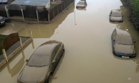 Cars and homes urrounded by floodwater