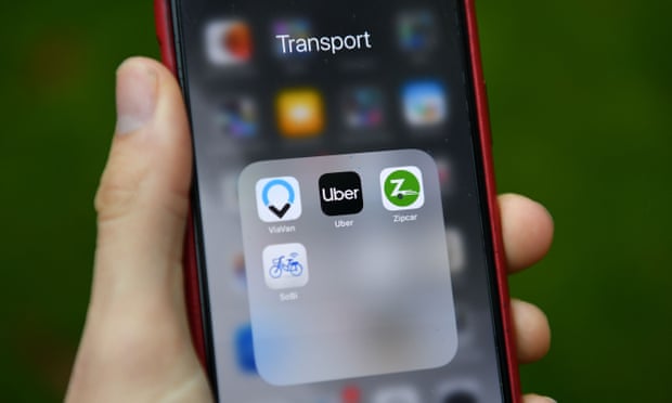 Transport apps including Uber and Zipcar are seen on a smartphone
