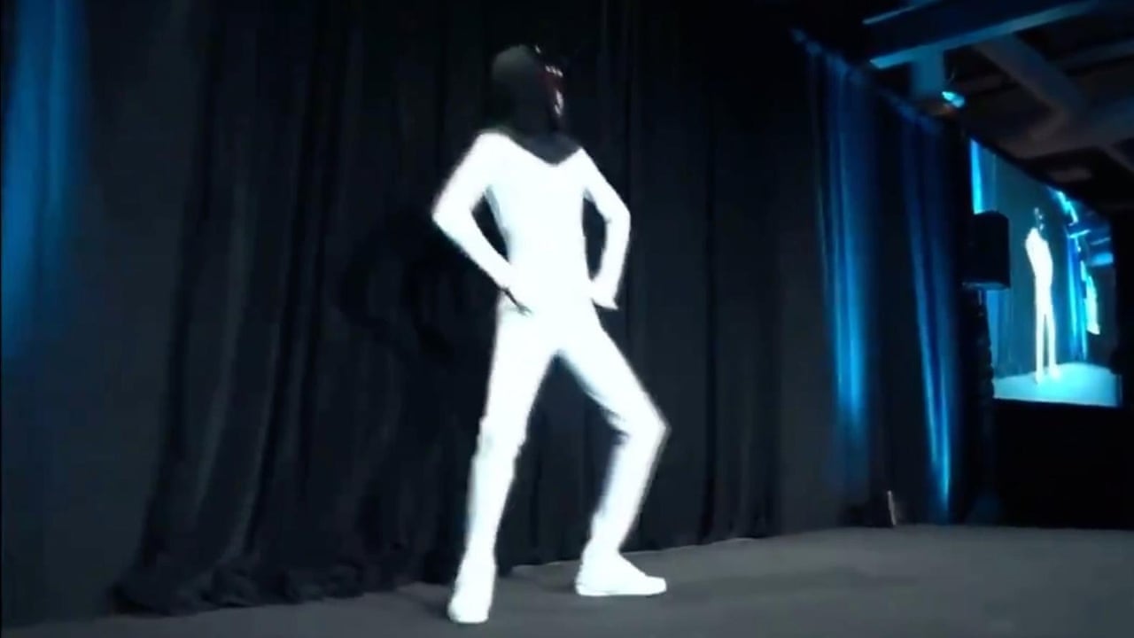 Elon Musk Unveils plan for 'Tesla Bot' with Man Dancing in a Bodysuit - Video
