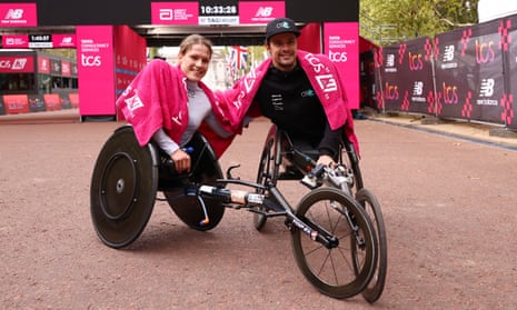 Catherine Debrunner and Marcel Hug celebrate after winning the Women's and Men's Elite Wheelchair Race