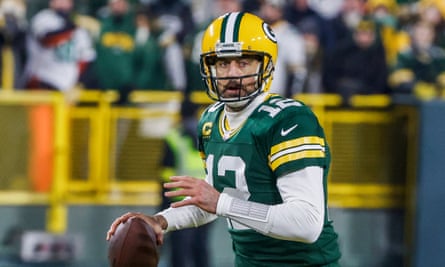 Aaron Rodgers holds a ball during a match