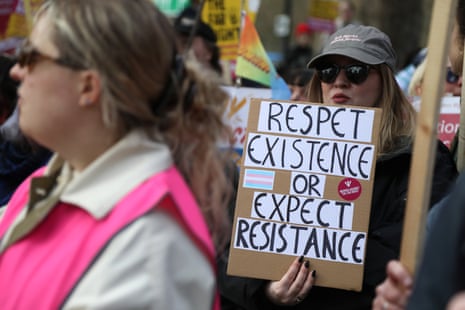 A protester holds a placard that reads “Respect Existence or expect resistance”.