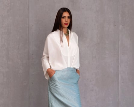 A woman with long brown hair in a slim-line skirt made from handwoven silk brocade and finished with deep pockets and a centre-back slit