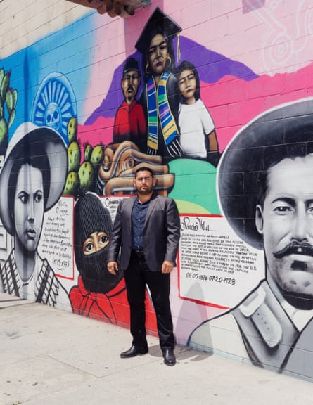 A man successful a suit stands for a image successful beforehand of a colorful mural