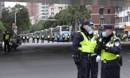 Police keep watch at an intersection on Thursday near the hospital where Jiang is rumoured to have died in Shanghai