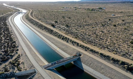 An aqueduct carrying water through a desert.