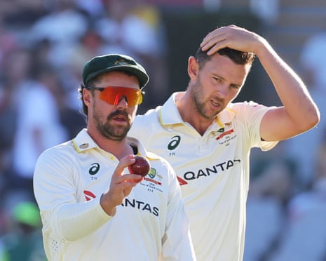 Travis Head and Josh Hazlewood inspect the ball as South Africa host Australia on day four of the third Test at Newlands in Cape Town