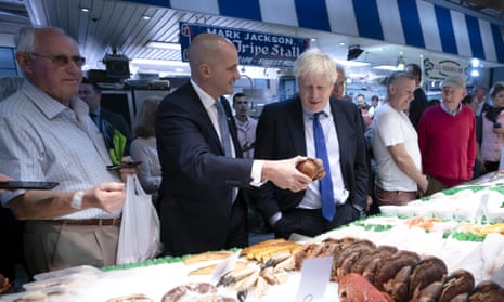 Jake Berry, second left, talks to Boris Johnson as they stop at a fishmongers during a visit to Doncaster Market, September 2019.