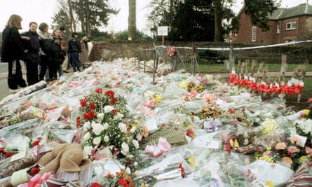 People lay flowers outside Dunblane primary school on 14 March 1996