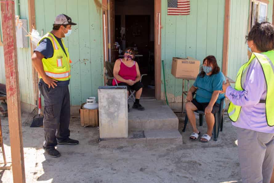 Eric Trevizo, a team leader for the Northern Diné Covid-19 Relief Effort, delivers necessities to people like Emily John and daughter April, both diabetic, whose home had no electricity or running water.